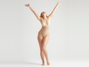 seamless solutions - high waist shaping brief in Almond worn by a woman standing facing forward with arms raised in the air and head thrown back Yummie