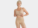 A woman is wearing the Sadie Shapewear and a Shaping Short in Almond while standing facing forward. Yummie Tank Top w/ Built In Bra and 