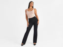 A woman is wearing the Anna Scoop Neck Shaping Tank Top - 360Sculpt™ Cotton in Almond with a black flare legging while standing . Yummie
