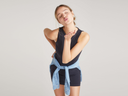 tank smoothing dress in Black worn by a woman fbent forward, right hand on back and left hand blowing a kiss Yummie